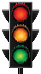 traffic light showing lights colored: red at top, yellow in middle and green at bottom