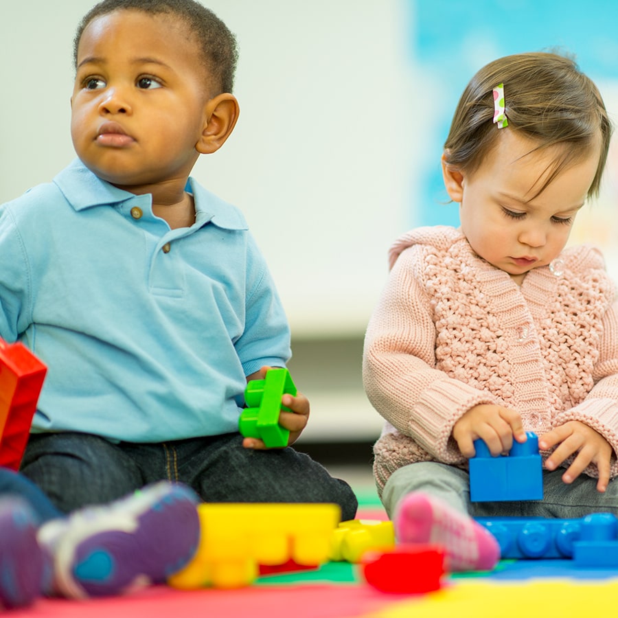 babies playing with blocks