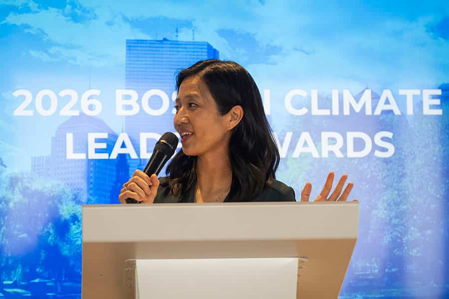 Mayor Michelle Wu stands at a podium, delivering a speech at the Climate Leadership Awards