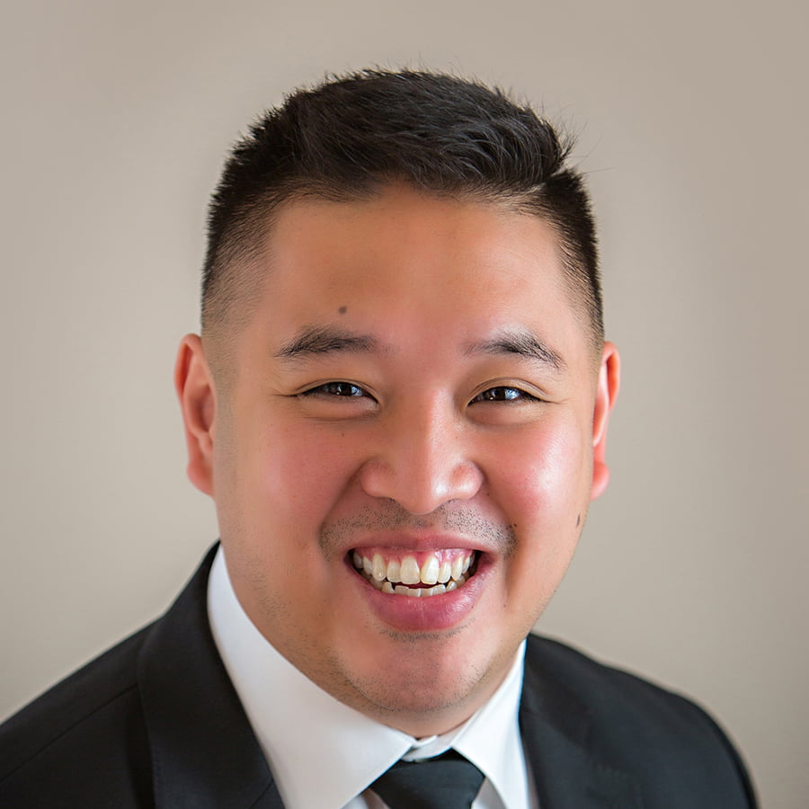 Headshot of student, Benny, wearing a suit.