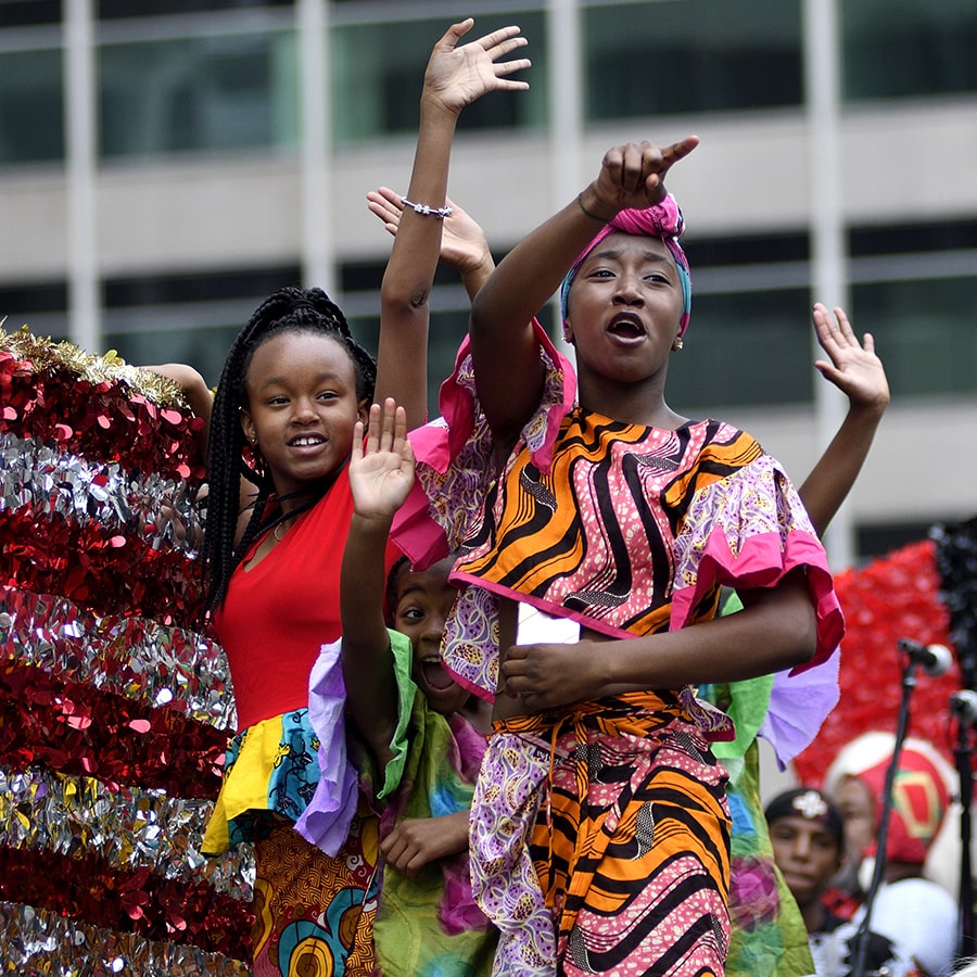 Philadelphia, PA, USA - June 23, 2018; Children on a float wave to the crowd during the annual Juneteenth parade in Center City Philadelphia, PA, on June 23, 2018.