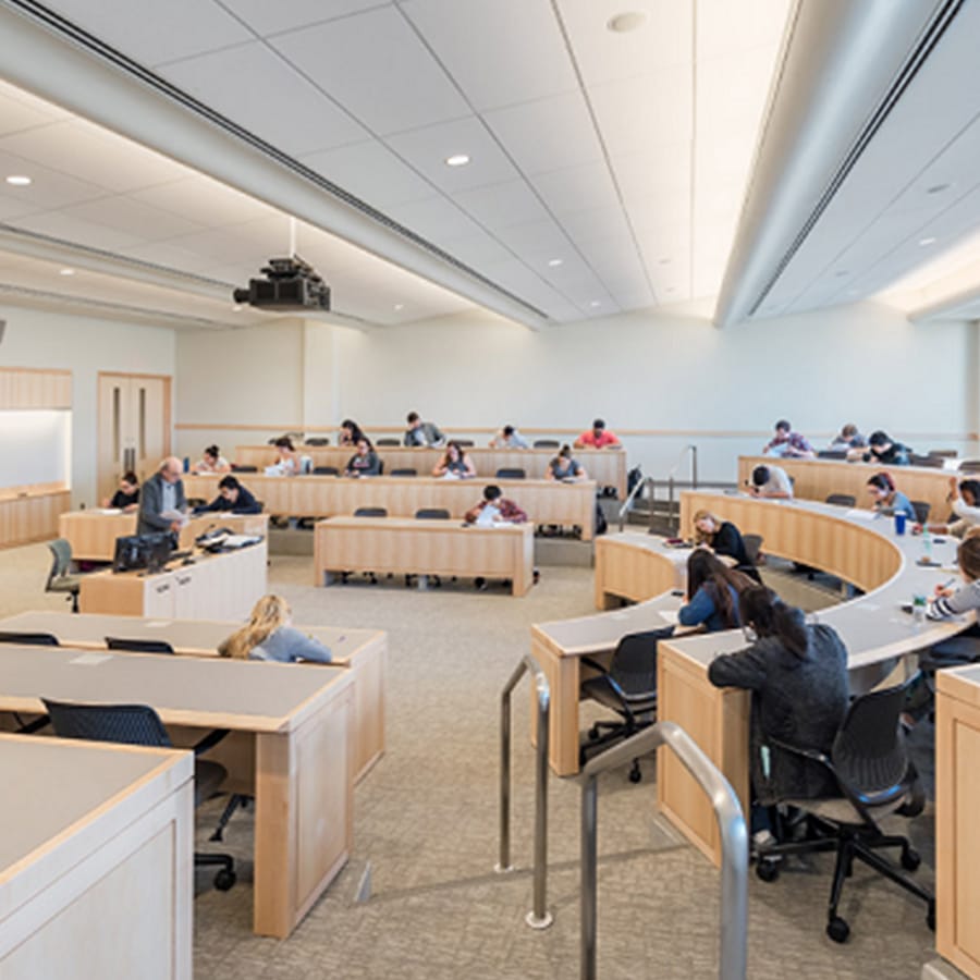 A classroom room in university hall with stadium style seating.