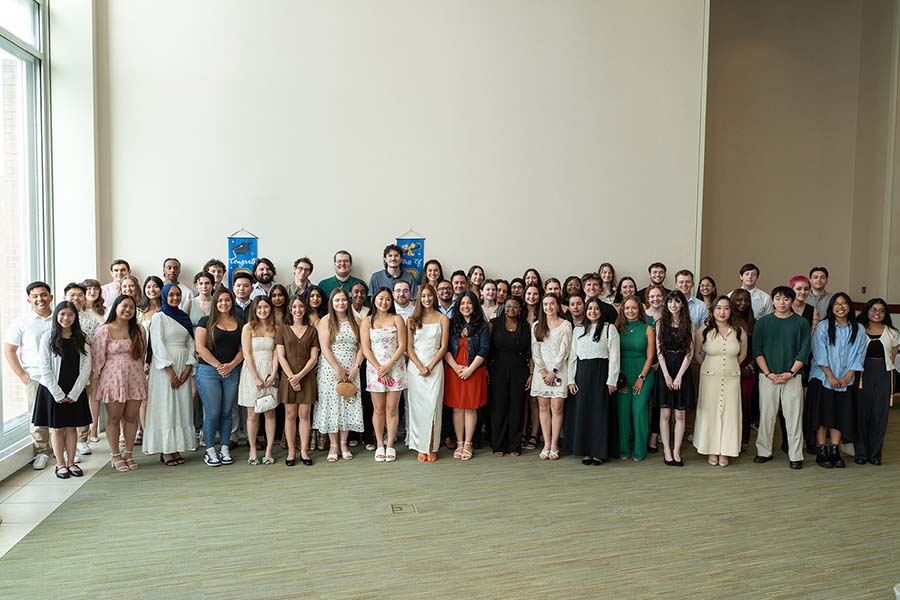 graduates standing against wall